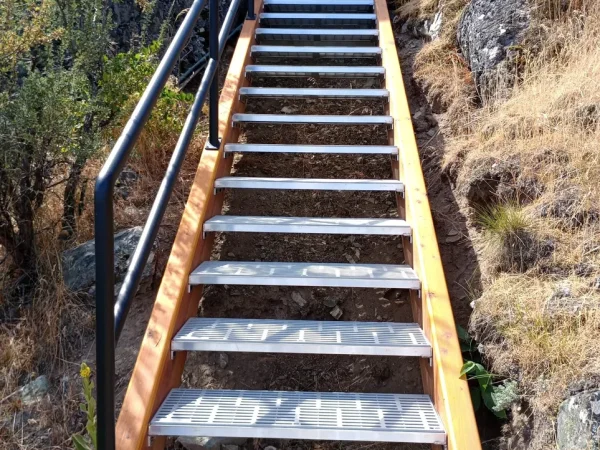 Custom Concrete-Backed Staircase with Glulam Beams - Image 6 by Cabe Construction, LLC